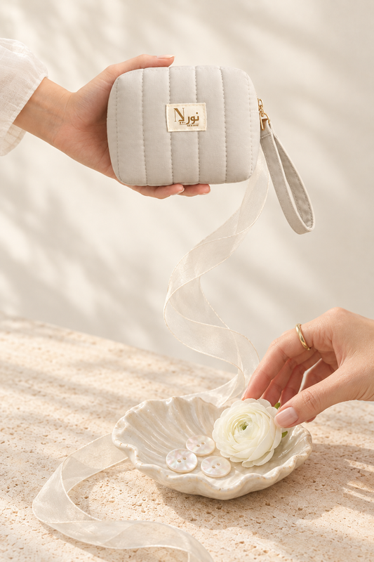 Ivory Nuri pouch with connected shell and flower still life