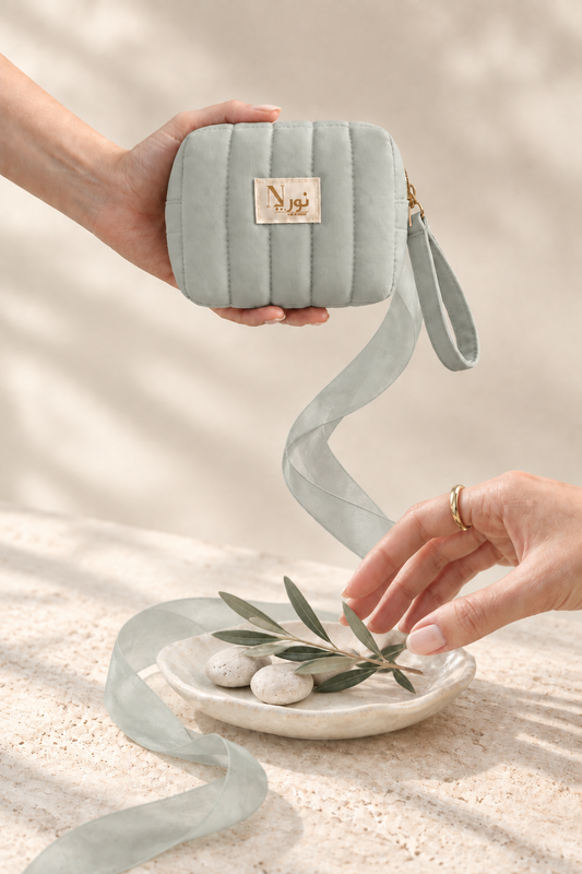 Light sage Nuri pouch with botanical still life
